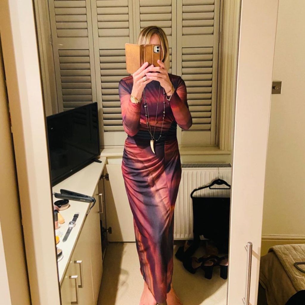 Carol McGiffin taking a mirror selfie in a tie-dye dress