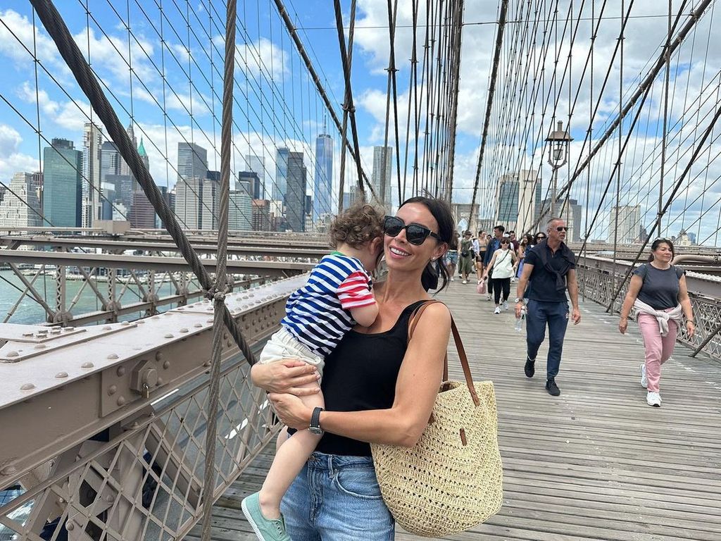 Christine holding Freddy on a bridge in NYC 