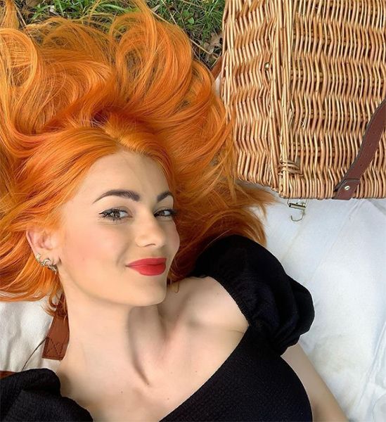 dianne buswell orange hair laying in field
