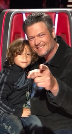 Blake Shelton sits with Apollo on his lap at The Voice