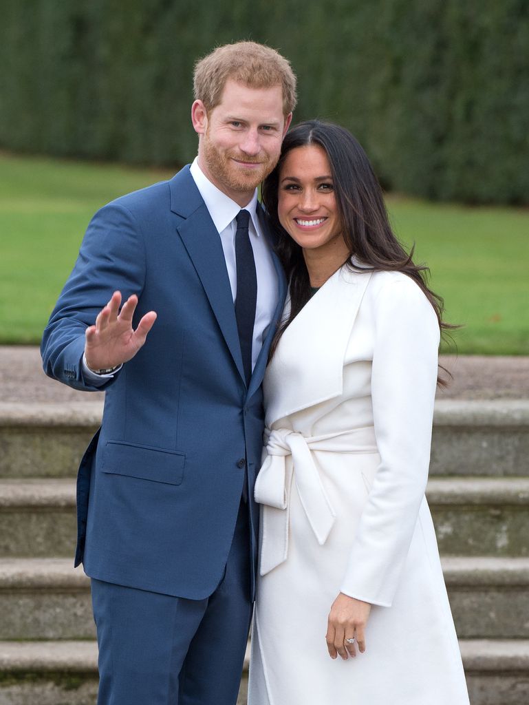 Prince Harry and Meghan Markle standing in a garden