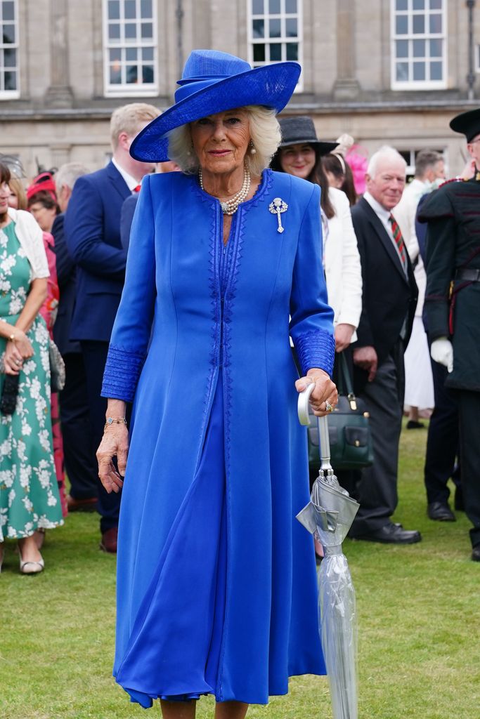 Queen Camilla in blue hat and dress at garden party