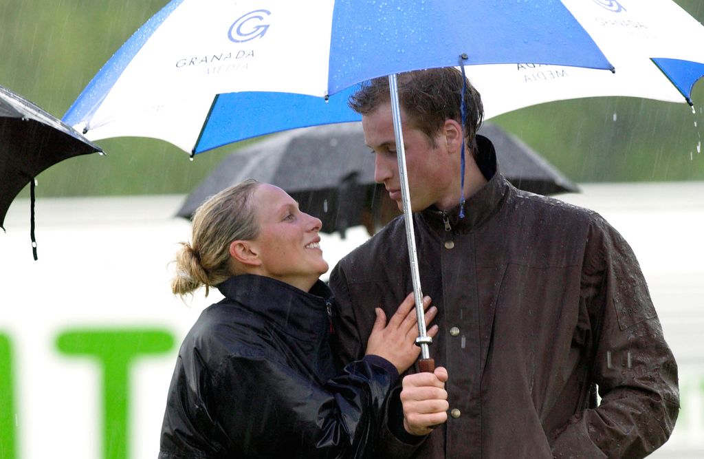 Royal Cousins Prince William And Zara Phillips Shelter under An Umbrella In A Downpour Of Rain 