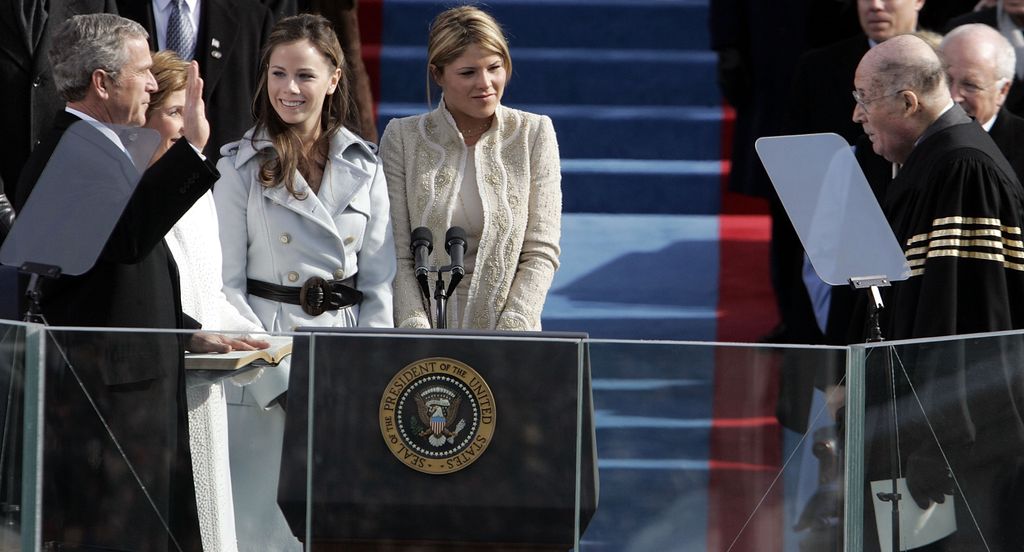 U.S. President George W. Bush (L) takes the oath of office from U.S. Supreme Court Chief Justice William Rehnquist (L) during inaugural ceremonies with (L to R) first lady Laura Bush and daughters Barbara Bush and Jenna Bush looking on at the west front o