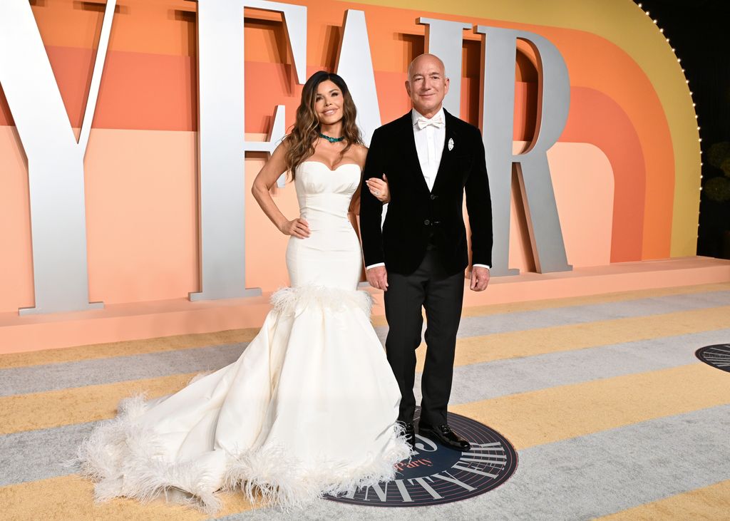 photo of lauren sanchez wearing white gown and jeff bezos in black tux at vanity fair oscars party