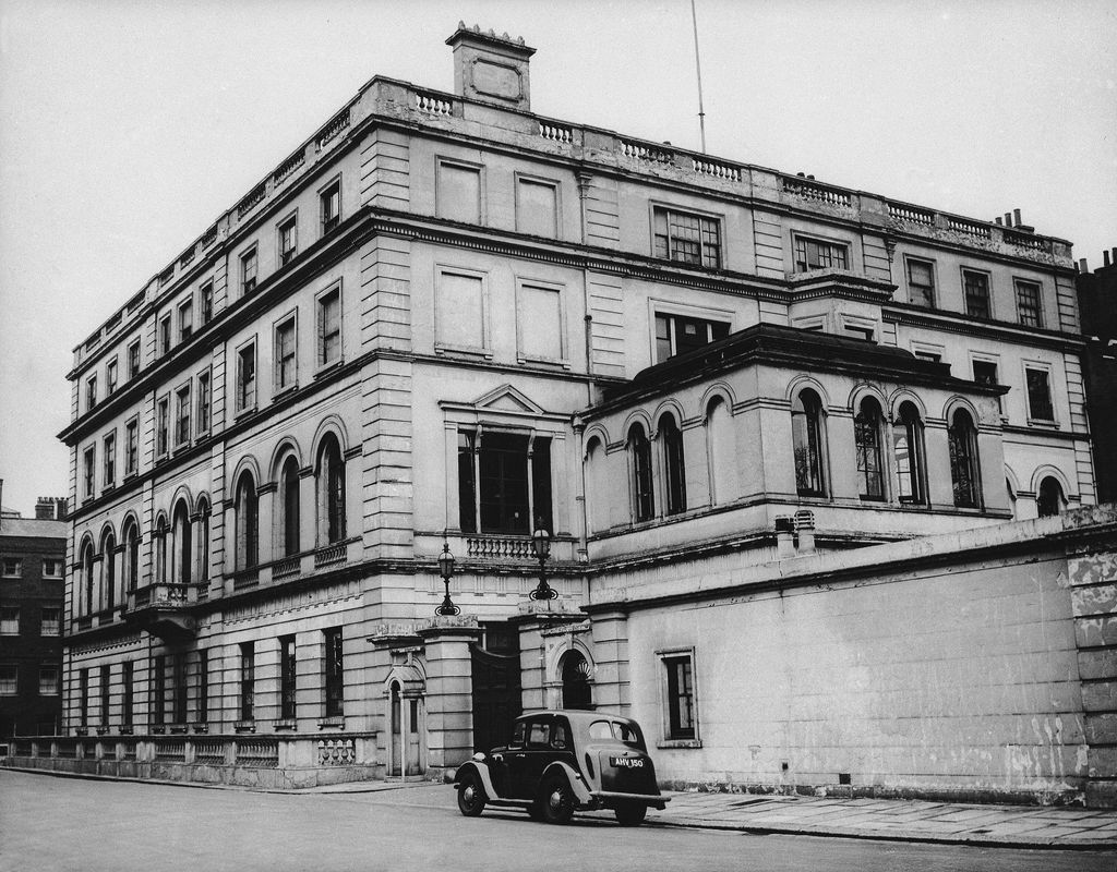 A black-and-white exterior shot of Clarence House with a car outside