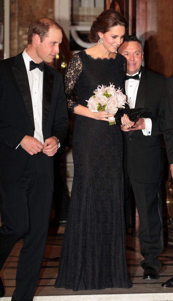 Kate in black lace gown holding bouquet