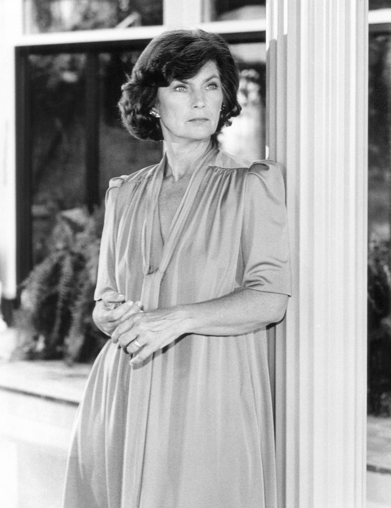 Priscilla Pointer in a long, floaty dress looking out with a serious expression 