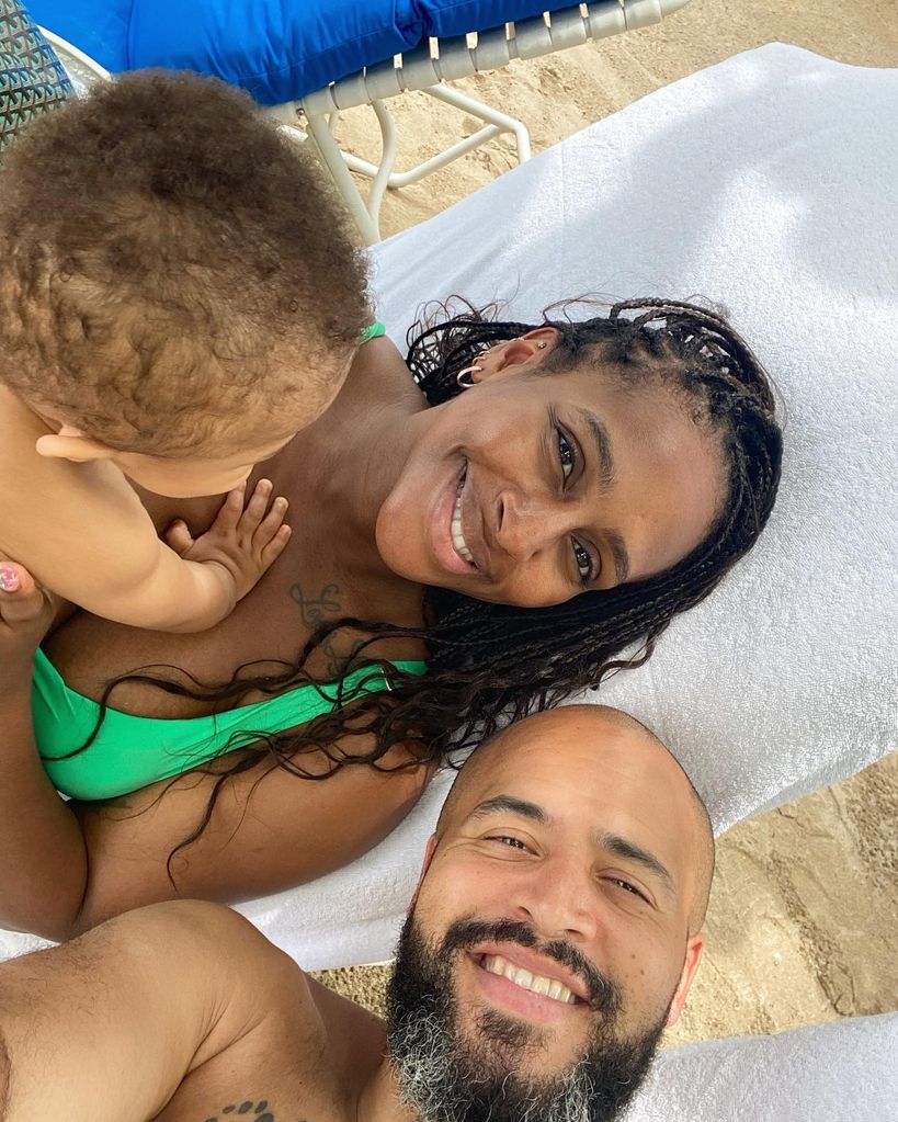 Alexandra Burke on sun lounger with baby and boyfriend