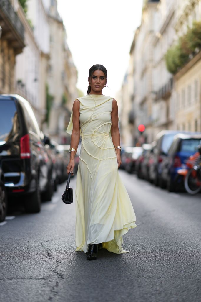 PARIS, FRANCE - SEPTEMBER 29: Camila Coelho wears a sleeveless pastel pale gathered long flowing dress, black shiny boots, outside Victoria Beckham, during the Womenswear Spring/Summer 2024 as part of  Paris Fashion Week on September 29, 2023 in Paris, France. (Photo by Edward Berthelot/Getty Images)