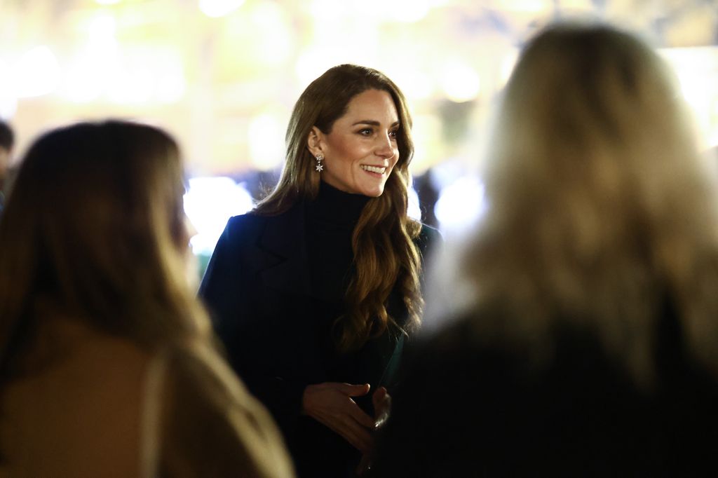 Kate Middleton smiling while wearing snowflake earrings