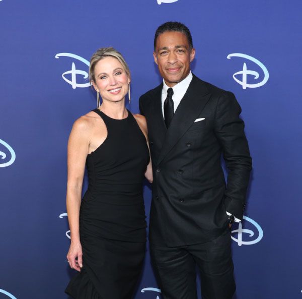 Amy Robach and T.J. Holmes smile at a Disney event before they were revealed as a couple 