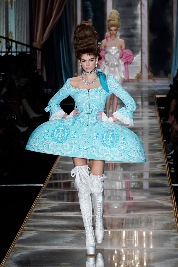 Kaia Gerber walks the runway during the Moschino fashion show as part of Milan Fashion Week Fall/Winter 2020-2021  in big victoriana blue dress