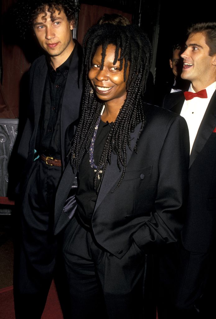 Whoopi Goldberg and her husband David Claessen in matching black suits