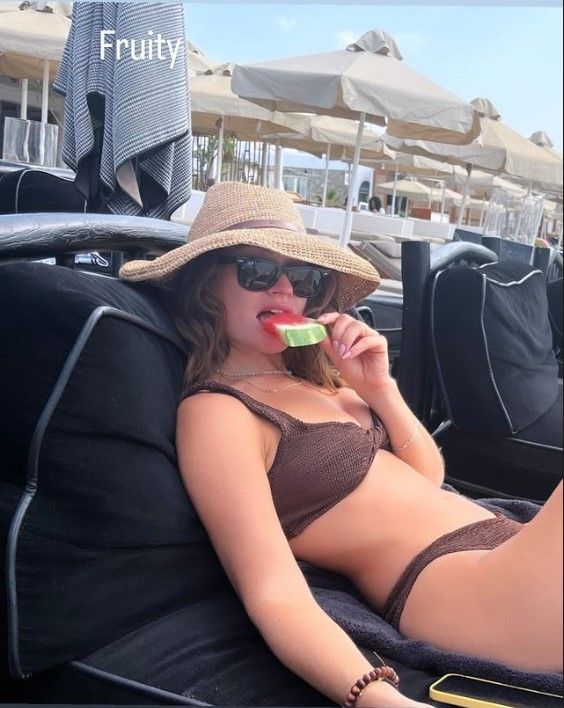 Lily James in brown Hunza G bikini eating watermelon slice