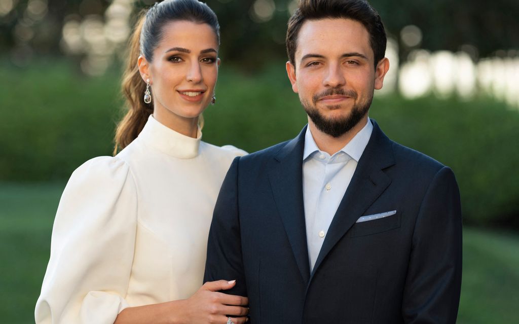 Jordan's Crown Prince Hussein in a suit with his fiancee Rajwa Al Saif wearing a white dress