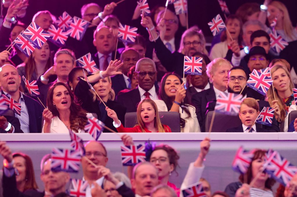 Kate, Charlotte and George waving flags at jubilee concert