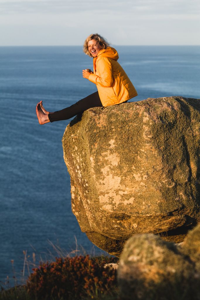 woman sitting on the edge of a cliff 