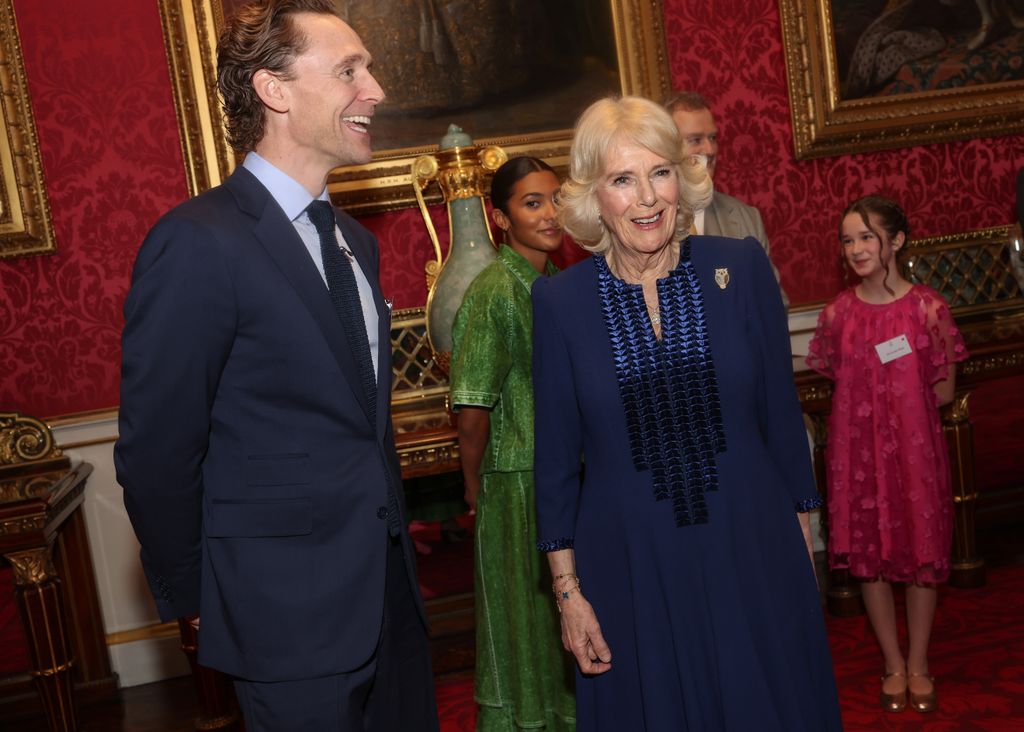 Queen Camilla shares a joke with Tom Hiddleston 