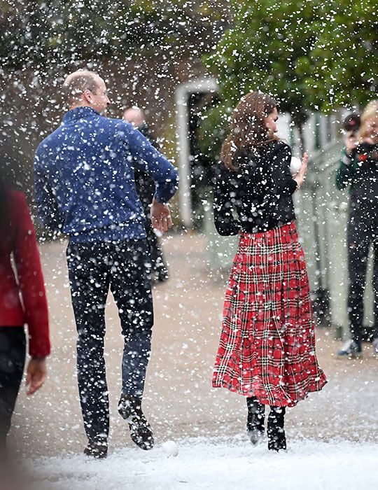 Prince William and Kate walk through fake snow at Kensington Palace in 2018