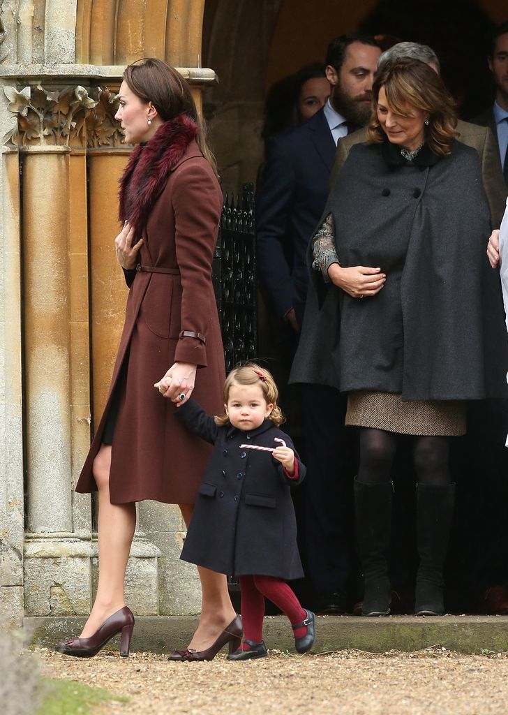 The then-Duchess of Cambridge, holding Charlotte's hand whilst parents Carole Middleton and Michael Middleton follow closely behind after attending Church on Christmas Day on December 25, 2016 