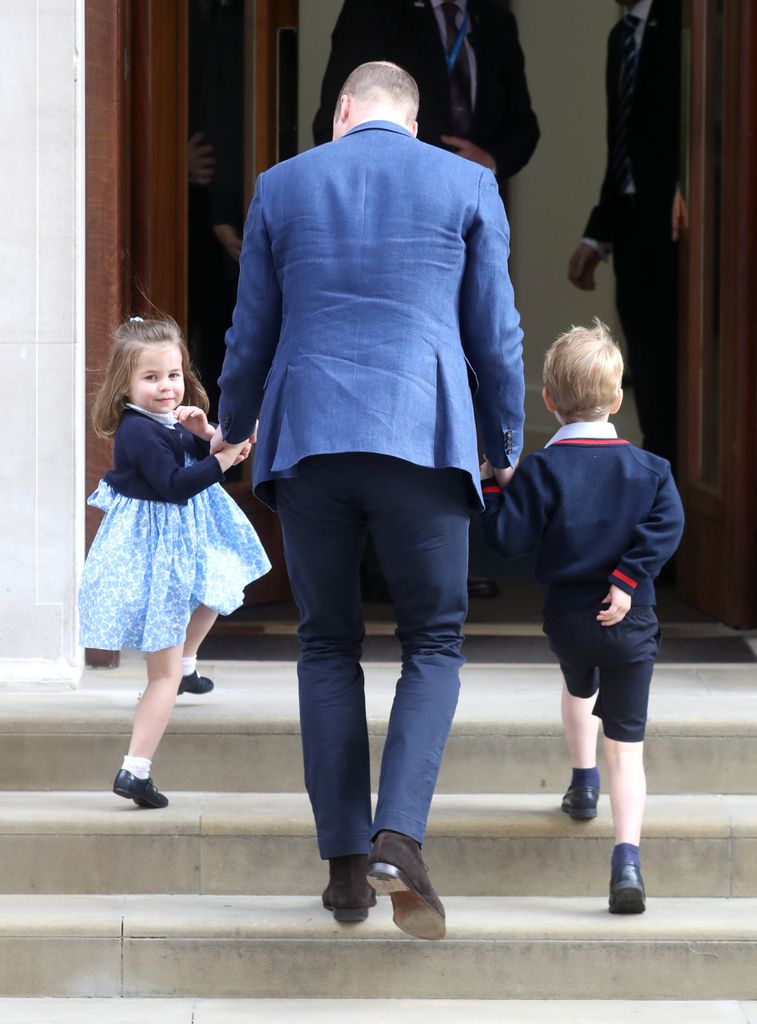 Princess Charlotte going up steps with william and george