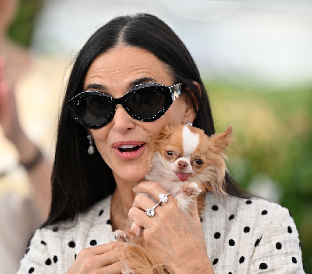 Demi Moore poses with her Chihuahua held up to her face
