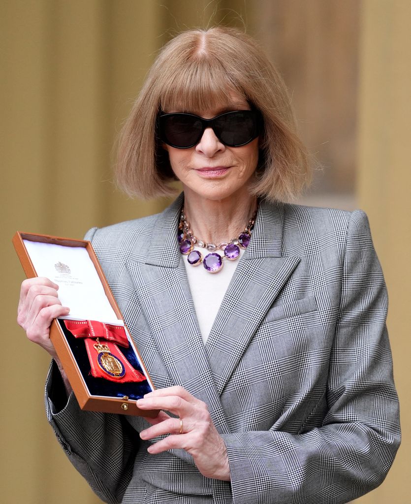 Anna Wintour posing with her medal awarded for Member of the Order of the Companions of Honour 