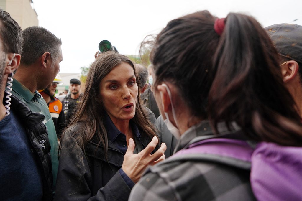 Queen Letizia of Spain talks with a person as angry residents heckled during the Spanish royal couple's visit to Paiporta,