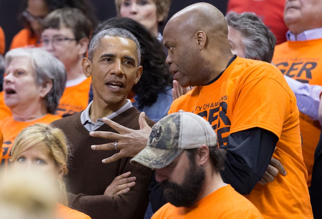 U.S. President Barack Obama sits beside his brother-in-law Craig Robinson while attending the Green Bay versus Princeton women's college basketball game in the first round of the NCAA tournament, March 21, 2015 in College Park, Maryland. President Barack Obama's niece Leslie Robinson plays for Princeton.