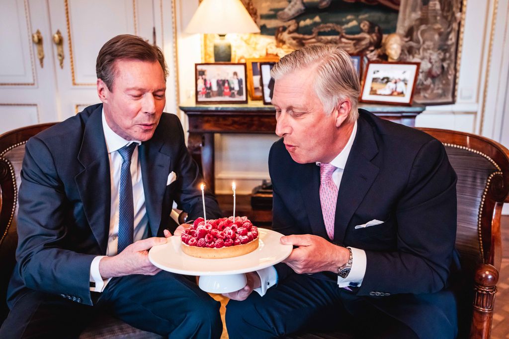 King Philippe and Grand Duke Henri blowing out candles on their birthday