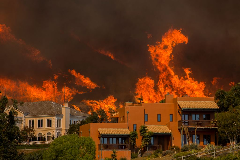 The Woolsey Fire approaches homes on November 9, 2018 in Malibu, California. About 75,000 homes have been evacuated in Los Angeles and Ventura counties due to two fires in the region