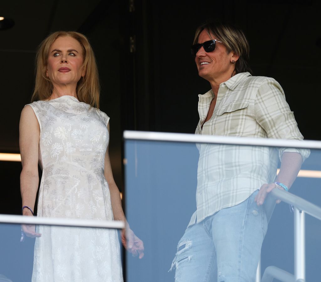 keith urban and nicole kidman talking in box at soccer game