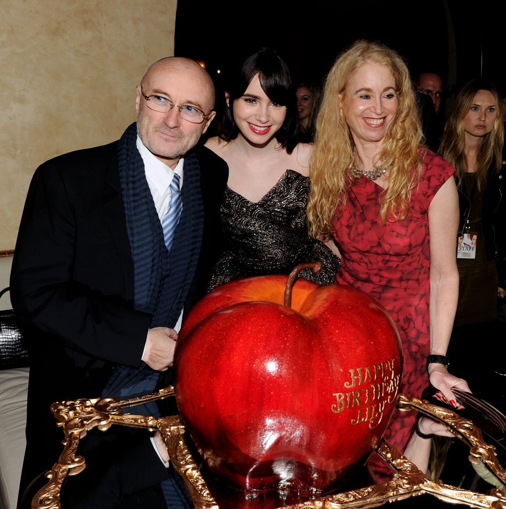 Phil Collins with Lily Collins and Jill Tavelman in front of a pumpkin