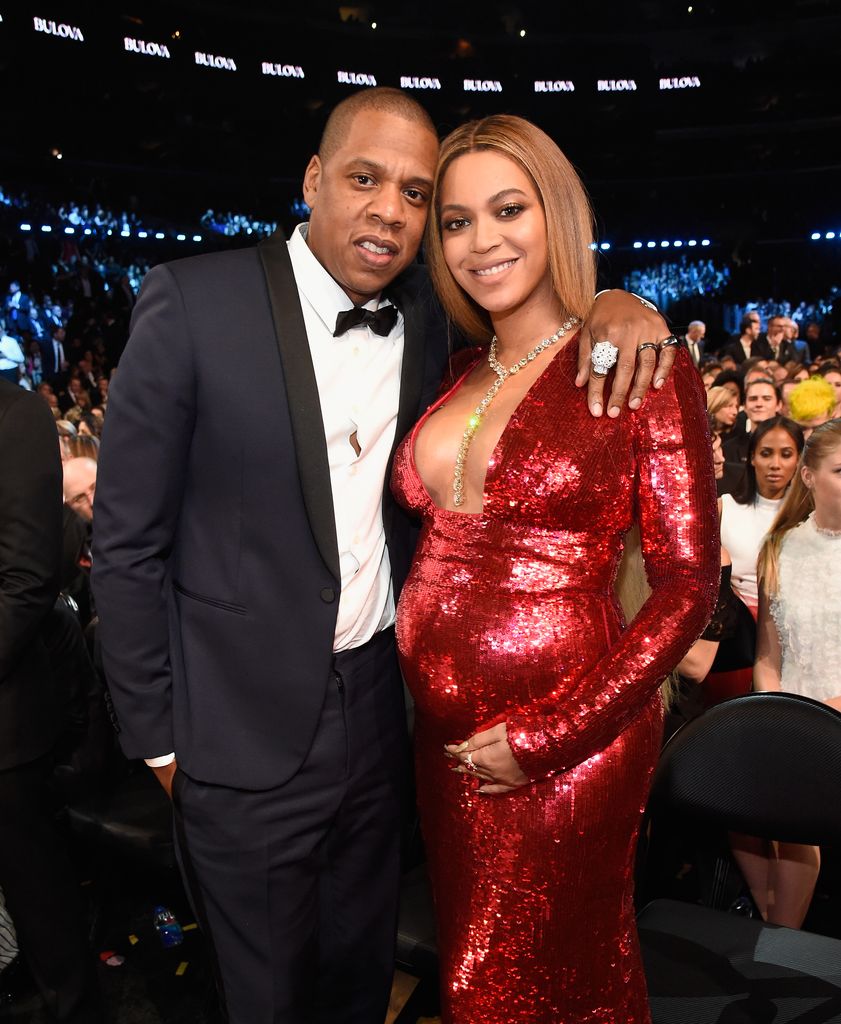 Beyonce and Jay-Z smiling at a fancy event, she is pregnant