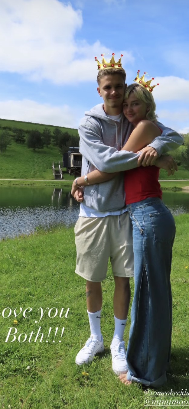 Mia Regan and Romeo Beckham hugging by a lake 