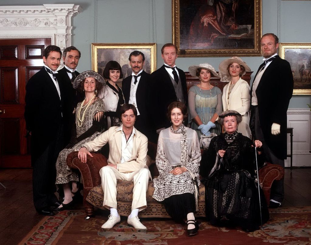 group of people in period dress posing for photo