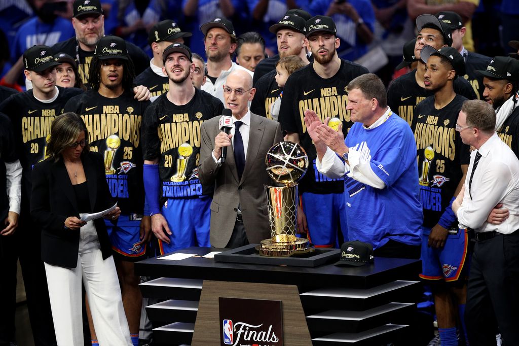 Adam Silver hands the Larry O'Brien Championship Trophy to Oklahoma City Thunder owner at the 2025 NBA Finals