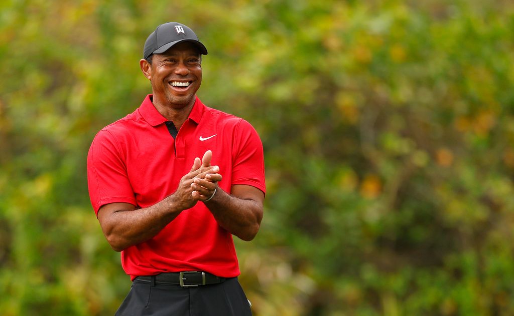 tiger woods smiling on golf course