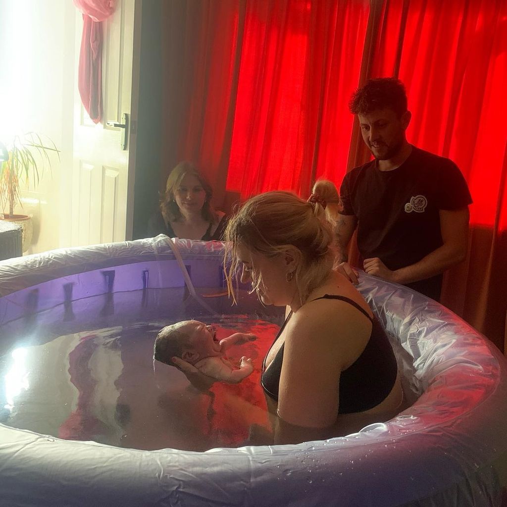 Ellie Warner cradling son Ezra after his pool birth