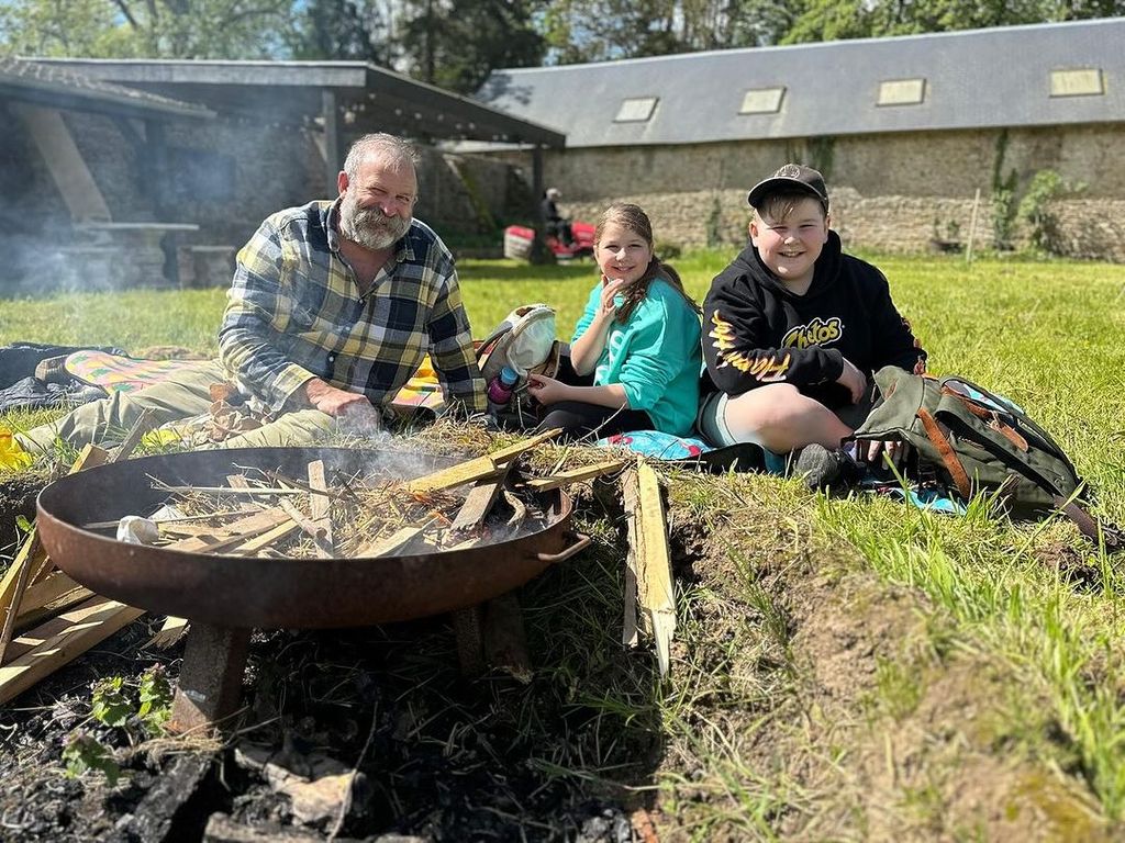 Dick Strawbridge with his two children in their garden at home