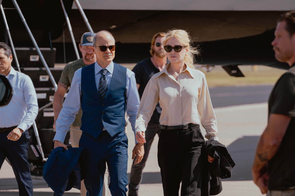 man and woman walking away from plane