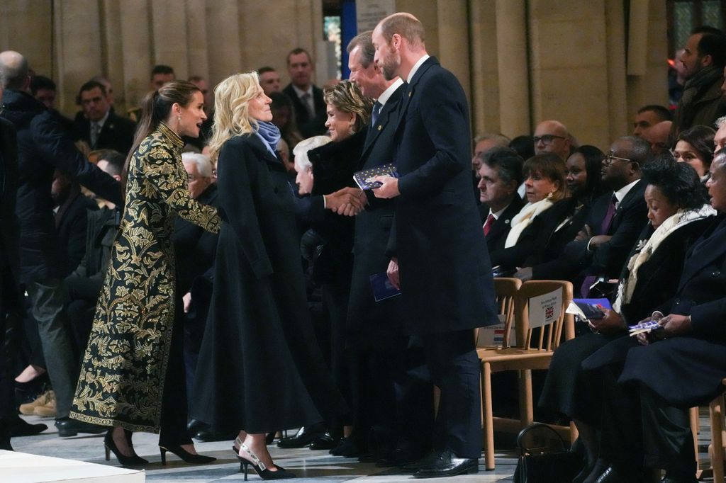 Britain's Prince William, Prince of Wales (R) welcomes First Lady of the United States Jill Biden (2nd L) and her daughter Ashley Biden (L) before a ceremony to mark the re-opening of the landmark Notre-Dame Cathedral 