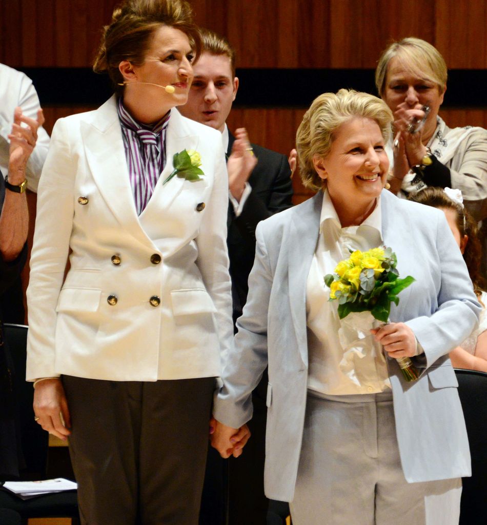 Debbie Toksvig in a white jacket and Sandi Toksvig in a blue suit at their vow renewal