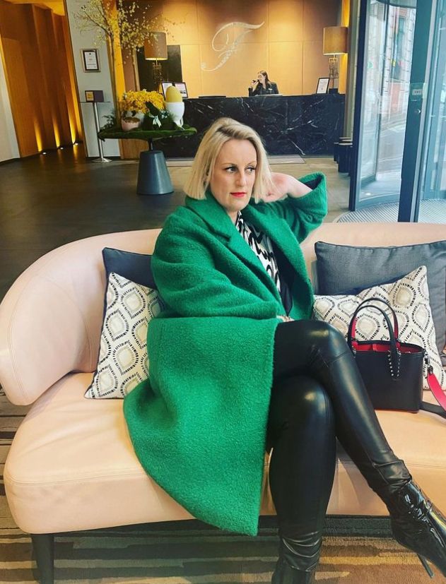 Steph McGovern looking morose in green overcoat and leather trousers