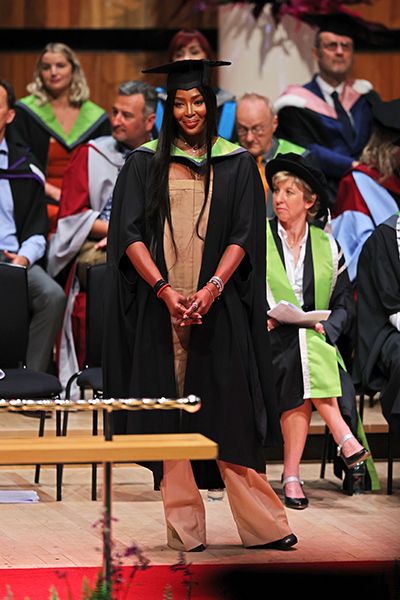 Naomi Campbell graduates in a Burberry jumpsuit