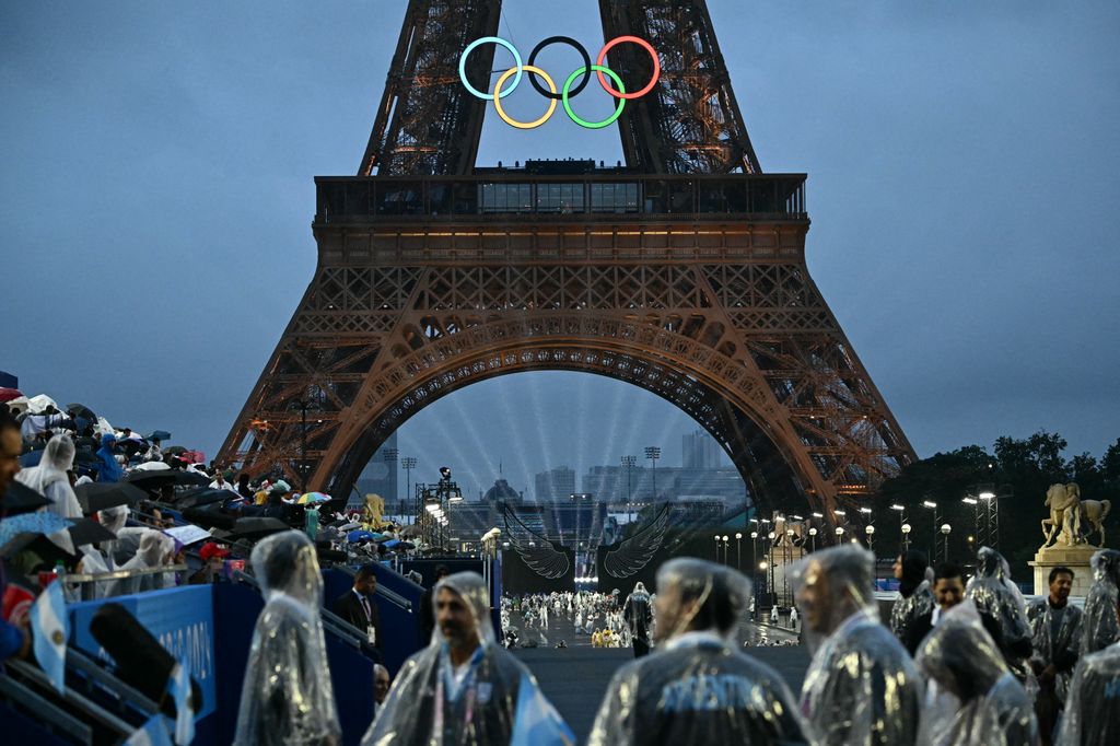 Delegations arrive at the Trocadero during the opening ceremony of the Paris 2024 Olympic Games in Paris on July 26, 2024 with the Eiffel Tower in the background.