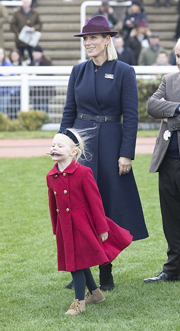 lena tindall in red coat with mum zara tindall on new years day races at cheltenham