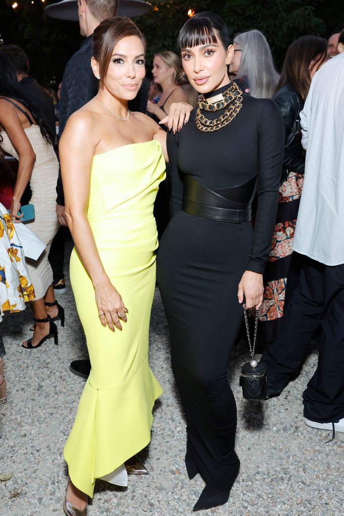 Kim's dramatic black look contrasted with Eva Longoria's bright summer column gown