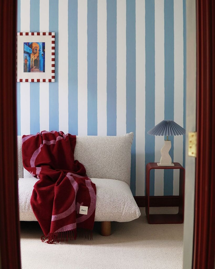 blanket on a sofa in a striped room